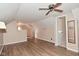 Neutral bedroom with wood-look floors, adjacent to another room with a window and wall paneling at 3533 N Grant Ave, Indianapolis, IN 46218