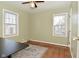 This bedroom features two windows, a ceiling fan, and hardwood floors with an area rug at 3533 N Grant Ave, Indianapolis, IN 46218