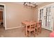 Open dining room with table for four and natural light from the french doors at 3533 N Grant Ave, Indianapolis, IN 46218