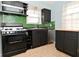 Efficient kitchen with stainless steel appliances and retro tile backsplash at 3533 N Grant Ave, Indianapolis, IN 46218