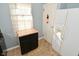 Bright kitchen area with a refrigerator and cabinet, complemented by a window for natural light at 3533 N Grant Ave, Indianapolis, IN 46218