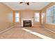 Bright living room features a classic fireplace, neutral carpet, and abundant natural light at 3533 N Grant Ave, Indianapolis, IN 46218