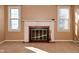 Bright living room with fireplace, neutral carpet, and two windows with coverings at 3533 N Grant Ave, Indianapolis, IN 46218