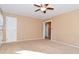 Spacious living room features neutral carpet, ceiling fan and great light at 3533 N Grant Ave, Indianapolis, IN 46218