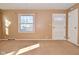 Cozy living room with neutral carpet and a window to let the sun shine in at 3533 N Grant Ave, Indianapolis, IN 46218