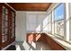 Enclosed sunroom with wood accents and many windows, creating a cozy and light-filled space for relaxation at 3533 N Grant Ave, Indianapolis, IN 46218