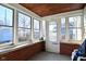 Bright sunroom with brick accents, multiple windows, and a door, creating a welcoming and light-filled space at 3533 N Grant Ave, Indianapolis, IN 46218