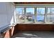 Cozy sunroom featuring brick accents, large windows providing views of the yard, and plenty of natural light at 3533 N Grant Ave, Indianapolis, IN 46218