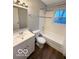 Bathroom with a single sink vanity, toilet, and a shower-tub combination at 3656 Allison Ave, Indianapolis, IN 46224