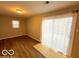 Bright dining area features modern floors, and a sliding door to the backyard at 3656 Allison Ave, Indianapolis, IN 46224