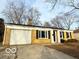 Charming single-story home with a yellow brick facade, attached garage, and well-maintained lawn at 3656 Allison Ave, Indianapolis, IN 46224