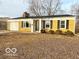 Charming single-story home with a yellow brick facade, attached garage, and well-maintained lawn at 3656 Allison Ave, Indianapolis, IN 46224