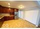 Traditional kitchen with brown cabinets, neutral countertops, a stainless steel refrigerator, and a light-colored floor at 3656 Allison Ave, Indianapolis, IN 46224