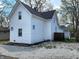 The property boasts a well-maintained white exterior with a neatly graveled yard at 498 Johnson Ave, Franklin, IN 46131