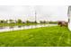 Expansive backyard featuring a pond, lush lawn, and inviting deck at 5650 Goodwin St, Indianapolis, IN 46234