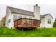Back of house featuring a wooden deck, well-kept lawn, and fenced backyard at 5650 Goodwin St, Indianapolis, IN 46234