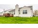 Well-maintained backyard featuring a wooden deck, verdant lawn, and the home's exterior with a chimney at 5650 Goodwin St, Indianapolis, IN 46234