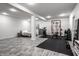 Finished basement featuring durable floors, a modern gym area, and a cozy bedroom space at 5650 Goodwin St, Indianapolis, IN 46234