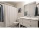Bright bathroom featuring a vanity with a white marble countertop and a framed mirror at 5650 Goodwin St, Indianapolis, IN 46234