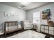 Well-lit Bedroom with a crib, recliner, decorative rug and a window at 5650 Goodwin St, Indianapolis, IN 46234