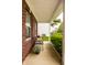 Relaxing covered front porch with decorative bench, lush greenery, and hanging flower baskets at 5650 Goodwin St, Indianapolis, IN 46234