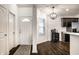 Inviting entryway with a decorative rug, white front door, and view of the open-concept kitchen at 5650 Goodwin St, Indianapolis, IN 46234