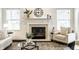 Living room with fireplace, neutral decor, and mantle with decorative accents at 5650 Goodwin St, Indianapolis, IN 46234