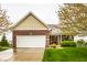 Charming single-Gathering home with brick and siding exterior, attached two-car garage, and well-manicured lawn at 5650 Goodwin St, Indianapolis, IN 46234