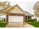Charming brick and siding single-Gathering home with a two-car garage and manicured lawn at 5650 Goodwin St, Indianapolis, IN 46234
