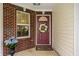 Welcoming front porch featuring a decorative wreath on the front door and lovely potted plants at 5650 Goodwin St, Indianapolis, IN 46234