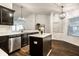Open kitchen with stainless steel appliances, white subway tile backsplash, and dark wood cabinets and center island at 5650 Goodwin St, Indianapolis, IN 46234
