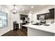 Modern kitchen with dark cabinets, stainless steel appliances, breakfast bar, and an open layout at 5650 Goodwin St, Indianapolis, IN 46234