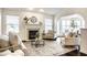 Bright and airy living room with a fireplace, neutral decor, and arched doorway at 5650 Goodwin St, Indianapolis, IN 46234