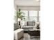 Living room with large windows, a comfortable gray sofa, and a modern oval coffee table at 5650 Goodwin St, Indianapolis, IN 46234