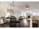 Bright open-concept living room featuring modern lighting, dark wood floors, and a fireplace at 5650 Goodwin St, Indianapolis, IN 46234
