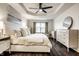 Bright bedroom featuring modern furniture, a ceiling fan, and tray ceiling at 5650 Goodwin St, Indianapolis, IN 46234