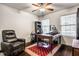 Office featuring a classic wooden desk, a comfortable leather recliner, and ample natural light at 5650 Goodwin St, Indianapolis, IN 46234