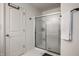 Bathroom features a shower with sliding glass door and a white door at 5650 Goodwin St, Indianapolis, IN 46234