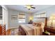 The bedroom has hardwood floors, natural light, a ceiling fan, and neutral paint at 717 Washington Ct, Anderson, IN 46011