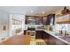 Contemporary kitchen with dark wood cabinetry, stainless appliances, and granite countertops at 717 Washington Ct, Anderson, IN 46011