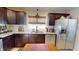 Kitchen featuring stainless steel appliances, granite countertops, and dark wood cabinets at 717 Washington Ct, Anderson, IN 46011