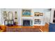 Living room showcasing a cozy fireplace, decorative artwork, and hardwood floors at 717 Washington Ct, Anderson, IN 46011