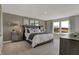 Luxurious main bedroom with a tufted headboard bed, neutral tones, and bright natural light at 7521 Amity Dr, Indianapolis, IN 46268