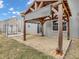 Backyard patio has a wooden pergola, grey privacy screen and is surrounded by grass at 878 Hollowood Ln, Avon, IN 46123
