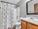 Bathroom with wooden vanity, tub-shower combo, and floral shower curtain at 878 Hollowood Ln, Avon, IN 46123