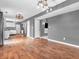 Open-concept living and dining area with wood floors and modern lighting at 878 Hollowood Ln, Avon, IN 46123