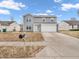 Charming two-story home with gray siding, a two-car garage, and a well-manicured lawn at 878 Hollowood Ln, Avon, IN 46123