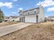 Two-story home with a two car garage and long concrete driveway at 878 Hollowood Ln, Avon, IN 46123