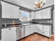 Renovated kitchen featuring stainless steel dishwasher, white cabinets and sink with dark countertops at 878 Hollowood Ln, Avon, IN 46123