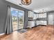 Charming eat-in kitchen with white cabinets, modern appliances, and sliding glass doors leading to the backyard at 878 Hollowood Ln, Avon, IN 46123